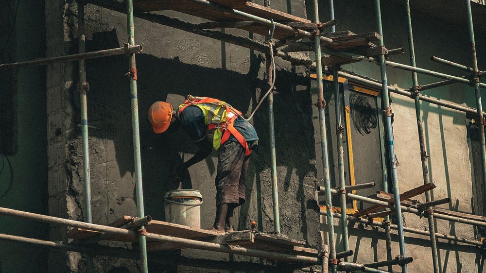 Mason plastering a wall
